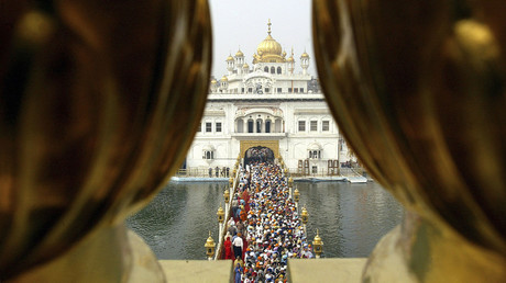 Devotees throng the holy Sikh shrine of Golden temple in the northern Indian city of Amritsar. © Munish Sharma