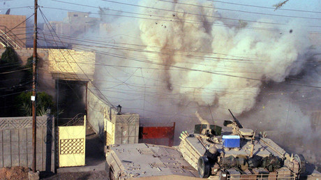 An M1A1 Abrams tank with the 2nd Tank Battalion returns fires into a building after U.S. Marines came under attack in Falluja, in this handout photo released December 16, 2004. © 