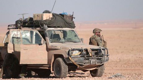 A U.S. fighter stands near a military vehicle, north of Raqqa city, Syria November 6, 2016. © Rodi Said