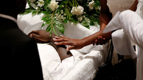 A family member touches the arm of police shooting victim Keith Lamont Scott during his funeral at the First Baptist Church in James Island, South Carolina, U.S. October 14, 2016. © Randall Hill