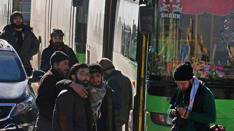 Men react as they stand outside buses evacuating people from a rebel-held sector of eastern Aleppo, Syria December 15, 2016