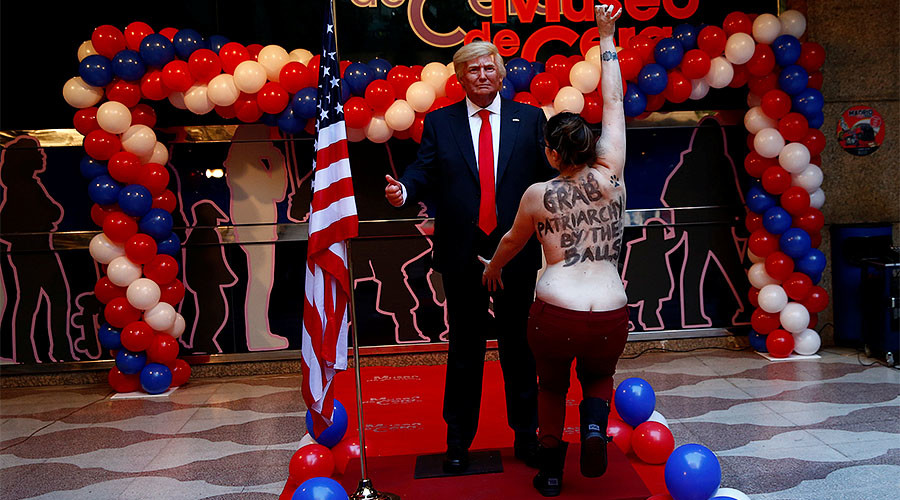 Topless FEMEN protester grabs Trump statue by crotch in Madrid