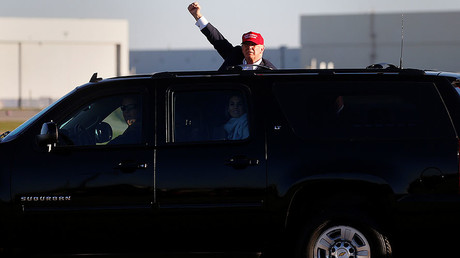 Donald Trump stands on the running board of an SUV and waves at an overflow crowd at a campaign rally in Minneapolis, Minnesota, U.S. November 6, 2016. © Carlo Allegri
