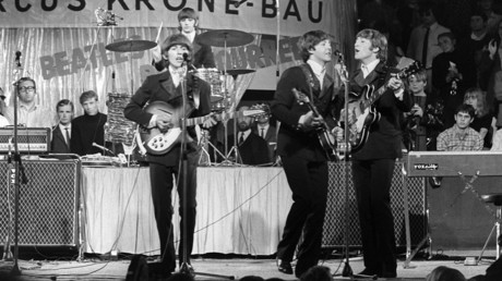 The Beatles (l-r) George Harrison, Paul McCartney, John Lennon and in the background Ring Starr at the drums, perform in Circus Krone in Munich on the 24th of June in 1966 in front of German audience. © Rauchwetter