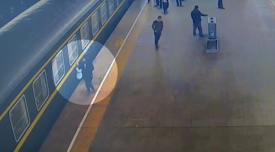 Stomach-churning moment 3yo falls under train at Chinese station caught on camera (VIDEO)