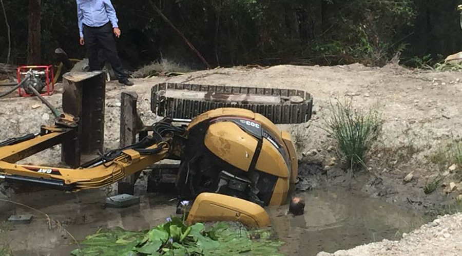 Gasping for air: Man trapped beneath digger in mud-filled dam fights for life (PHOTOS)