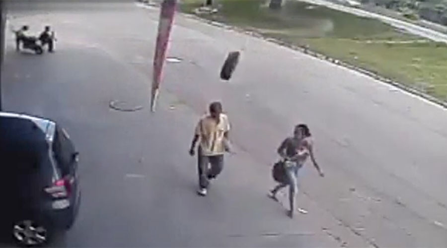 Freak runaway tire slams pedestrian into pavement (VIDEO)