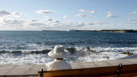 A woman sits at the embankment in the Black Sea city of Sevastopol, Crimea © Denis Sinyakov