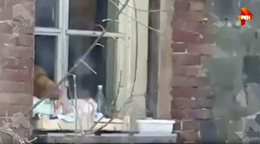 Woman questioned for hanging baby outside window, says she walks her child as she likes