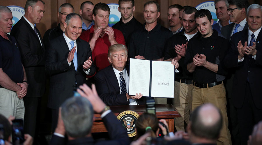 Trump revokes Obama climate change rules, declares end to ‘war on coal’
