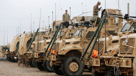 U.S. soldiers gather near military vehicles at an army base in Karamless town, east of Mosul © Ammar Awad