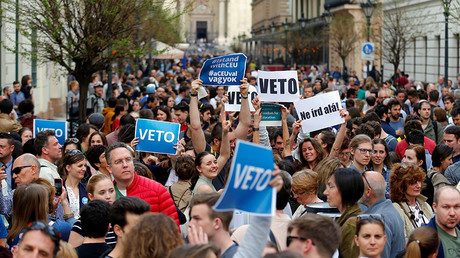 Demonstrators hold up banners during a rally in Budapest, Hungary, April 4, 2017 © Laszlo Balogh