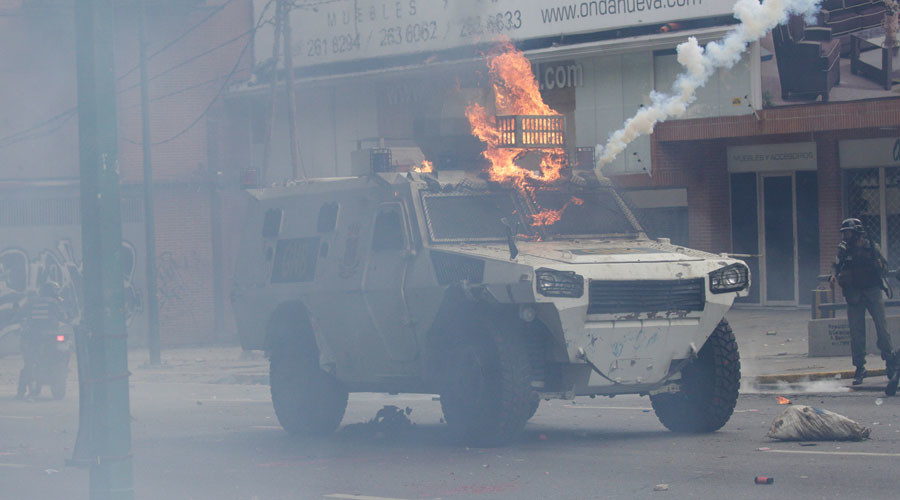 Armored vehicle set on fire plows through crowd in Venezuela (VIDEO)
