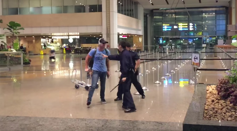 Drunken Aussie faces caning after expletive-laden scuffle with Singapore police at airport (VIDEO)