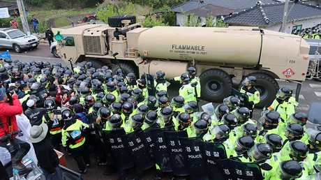 Protesters and police stand by as trailers carrying US THAAD missile defence equipment enter a deployment site in Seongju, early on April 26, 2017. © YONHAP