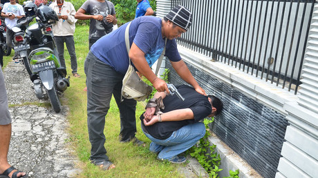 Plain clothes police recapture an escaped inmate from the jail in Pekanbaru, Riau province, on May 5, 2017 © Wahyudi 