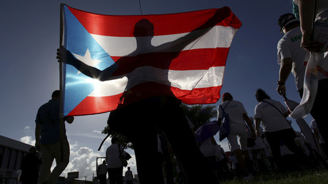 FILE PHOTO: A protester holding a Puerto Rico's flag © Alvin Baez