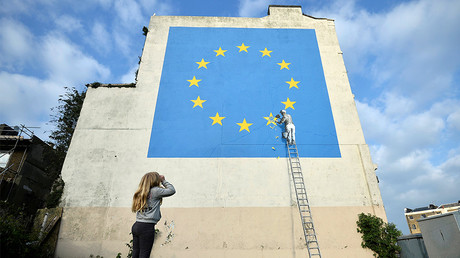A girl looks at artwork attributed to street artist Banksy, Dover, Britain, May 7, 2017. © Hannah McKay