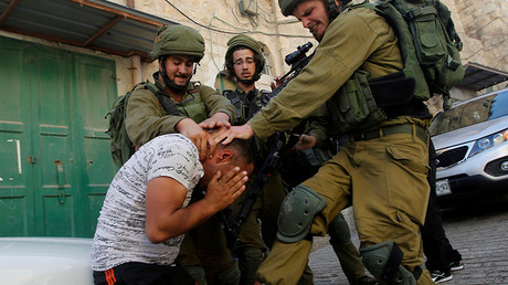 FILE PHOTO: Israeli soldiers detain a Palestinian, West Bank, Hebron. © Mussa Qawasma