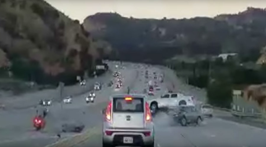 Highway road rage leads to fiery wreck after motorcyclist kicks car (VIDEO)