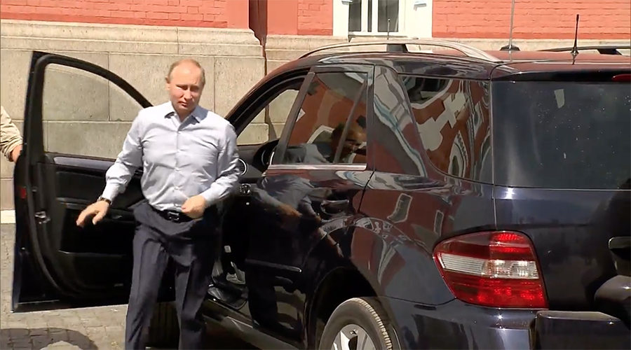 'Who's that passenger Putin is driving?' President's arrival at Russian monastery causes media hype