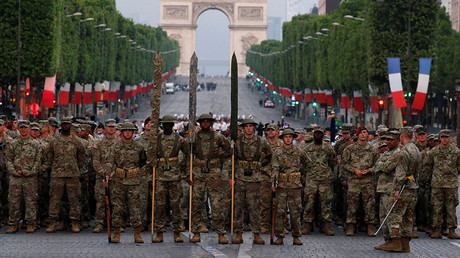 US troops, with soldiers wearing WWI helmets, walk on the Champs Elysees during a rehearsal of the traditional Bastille Day military parade in Paris, France, July 10, 2017. © Pascal Rossignol