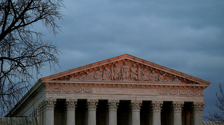 The top of U.S. Supreme Court building is lit at dusk in Washington © Joshua Roberts