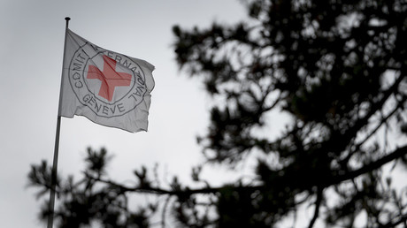 A flag flies at the top of the International Committee of the Red Cross (ICRC) headquarters in Geneva, Switzerland. © Fabrice Coffrini / AFP