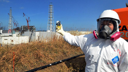 Checking radiation levels with a dosimeter near the stricken Tokyo Electric Power Co Fukushima Dai-ichi nuclear power. (AFP Photo / Yoshikazu Tsuno)
