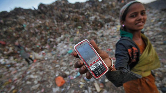 A ragpicker holds her mobile phone to show a picture she took at a dump yard on World Environment Day in New Delhi.(Reuters / Adnan Abidi)