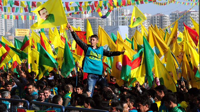 A Kurdish man waves a poster of founder of PKK (Kurdish Worker Party) Abdullah Ocalan during celebrations of Nowruz, the Persian New Year festival, on March 21, 2013 in Diyarbakir. (AFP Photo)