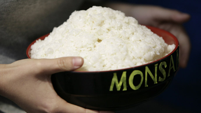 A Greenpeace activist holds a bowl of rice to protest in the lobby of a building where Monsanto, a U.S.-based multinational agricultural biotechnology corporation, has its office (Reuters)
