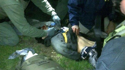 Handcuffed Dzhokhar Tsarnaev being frisked by a law enforcement after he was taken out of his last refuge in a boat before being transported to Mount Auburn Hospital.(Photo from twitter.com user @BMTrader)