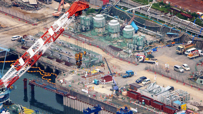 An aerial view shows workers wearing protective suits and masks work at a construction site (C) of the shore barrier to stop radioactive water from leaking into the sea at Fukushima Daiichi nuclear power plant on August 9, 2013. (Reuters/Kyodo)