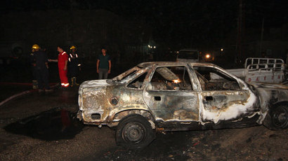 Iraqi security forces personnel inspect the site of a car bomb attack in Kerbala, 110 km (68 miles) south of Baghdad, August 10, 2013.(Reuters / Mushtaq Muhammed)