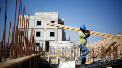 A labourer works on a construction site in Pisgat Zeev, an urban settlement in an area Israel annexed to Jerusalem after capturing it in the 1967 Middle East war August 12, 2013.(Reuters / Amir Cohen)