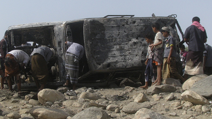 People gather at the site of a drone strike on the road between Yafe and Radfan districts of the southern Yemeni province of Lahj August 11, 2013. (Reuters)