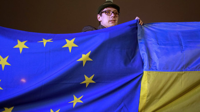 A protester holds Ukrainian and European Union flags during a rally to support euro integration in central Kiev  (Reuters/Gleb Garanich)