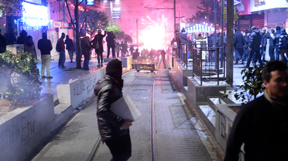 Demonstrators run away as they clash with riot police (unseen) during a protest against corruption in the Kadikoy district of Istanbul on December 25, 2013 (AFP Photo / Bulent Kilic)