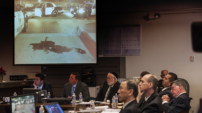 Former Fullerton police officers Jay Cicinelli (2nd L) and Manuel Ramos (2nd R) look on as an image of a pool of blood left after Fullerton police arrested Thomas Kelly is shown to the jury during the opening statements by Orange County District Attorney Tony Rackauckas (not shown) in the People v. Ramos and Cicinelli trial at Orange County Superior Court in Santa Ana, California, December 2, 2013. (Reuters / Bruce Chambers)