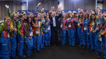 President Vladimir Putin, center, meets with the volunteers taking part in preparing and holding the 22nd Winter Olympic Games and 11th Winter Paralympic Games in Sochi. (RIA Novosti/Aleksey Nikolskyi)