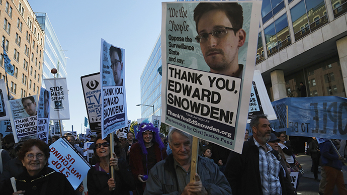 Demonstrators hold signs supporting former NSA contractor Snowden as they march at "Stop Watching Us: A Rally Against Mass Surveillance" near the U.S. Capitol in Washington (Reuters / Jonathan Ernst)