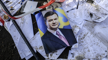 A picture of Ukraine's President Viktor Yanukovich is seen on the ground in Kiev, February 21, 2014. (Reuters / Andrew Kravchenko)
