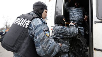 Members of Berkut anti-riot unit embark in a bus as leave their barracks in Kiev February 22, 2014. (Reuters / Yannis Behrakis)