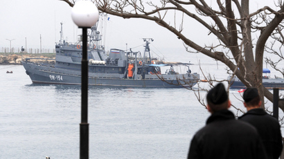 Ukrainian marines look at a Russian ship floating out of the Sevastopol bay on March 4, 2014 (AFP Photo / Viktor Drachev)