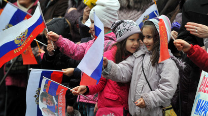 Children wave Russian flags during a mass pro-Russian rally in the center of Sevastopol, on March 8, 2014.(AFP Photo / Viktor Drachev)