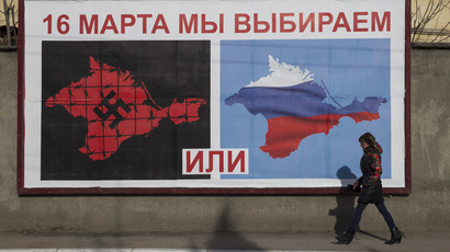 A woman walking by a poster calling people to vote in the upcoming referendum, in the Crimean port city of Sevastopol (Reuters / Baz Ratner) 