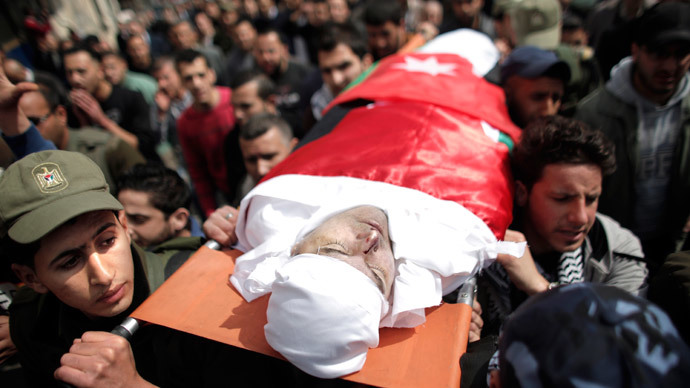 Palestinians carry the body of Raed Zeiter, 38, during his funeral in the northern West Bank city of Nablus, on March 11, 2014, a day after he was shot dead by the Israeli military. (AFP Photo / Ahmad Gharabli)
