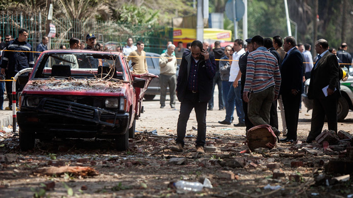 Egyptians inspect the damage after twin bombs struck police posts near Cairo University in the centre of Egypt's capital on April 2, 2014, which was followed by a third blast as police and journalists gathered at the scene. (AFP Photo / Manmoud Khaled)