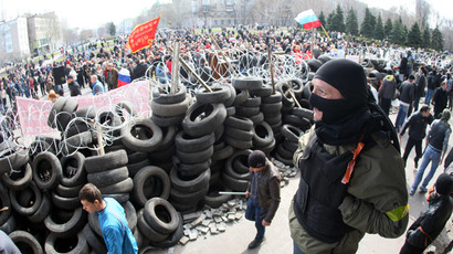 Pro-Russian activists guard a barricade set at the Ukrainian regional Security Service building on the eastern city of Donetsk on April 7, 2014.(AFP Photo / Alexander Khudoteply)